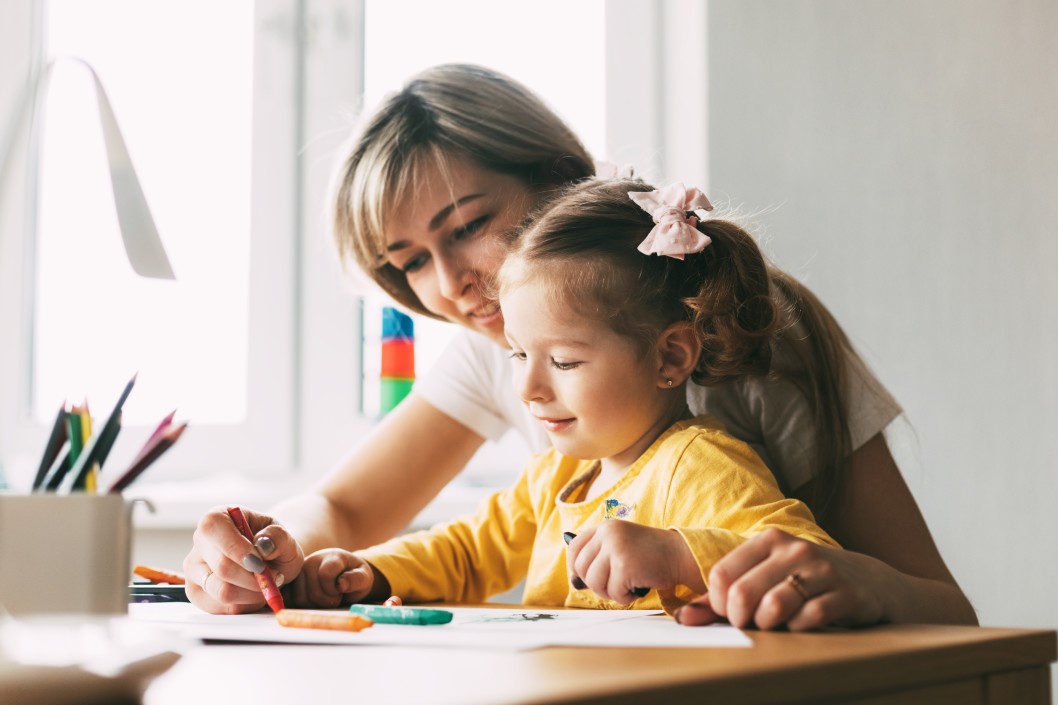 Child doing art with parent