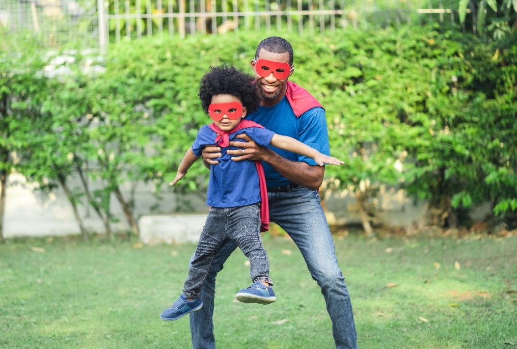 Father and son in superhero masks