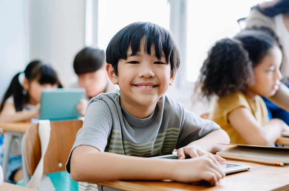 young boy smiling in class
