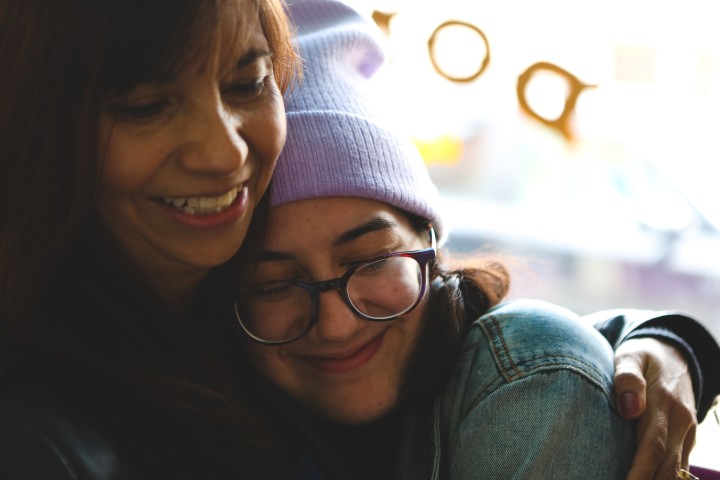 Mother hugging daughter