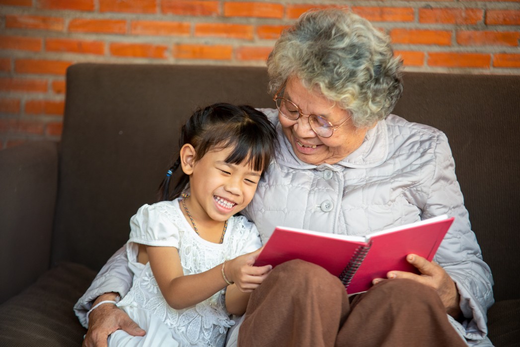 Grandparent reading with granddaughter