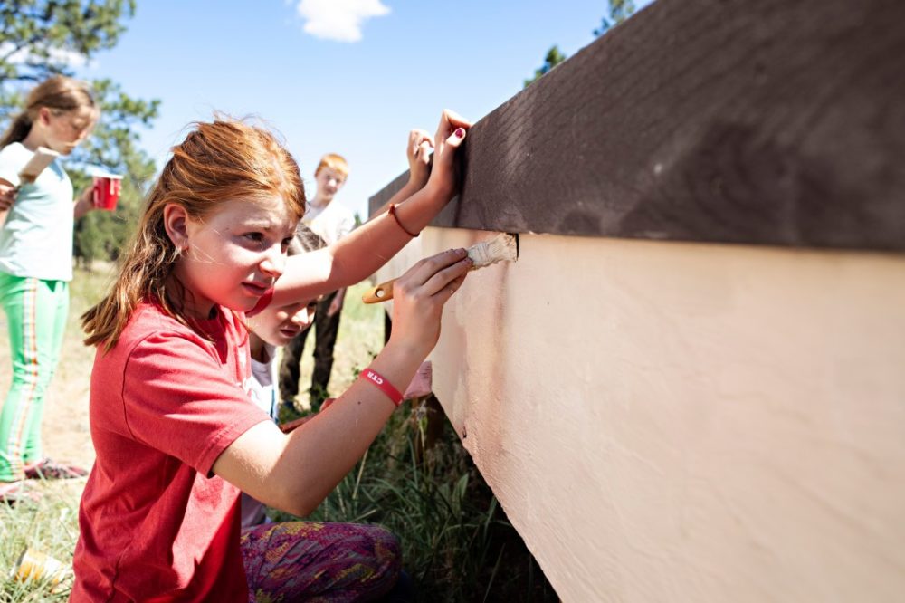 kids painting on a service project