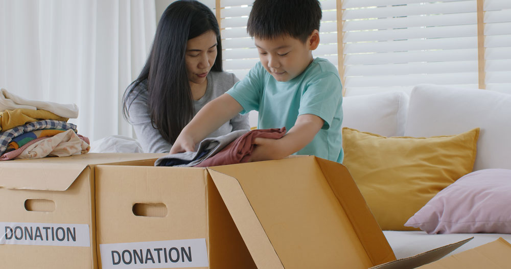 Mother and son donating clothes