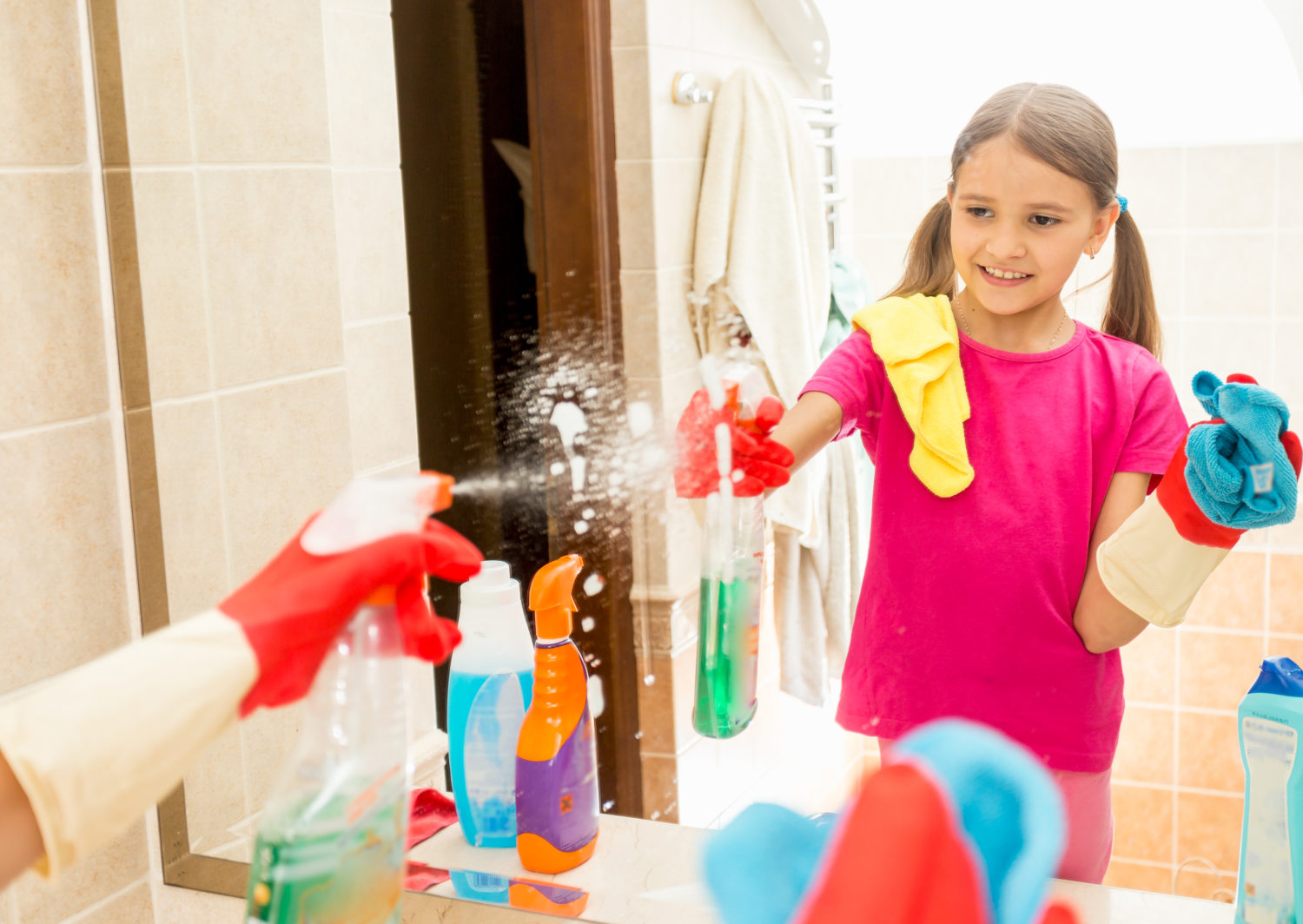 girl cleaning mirror