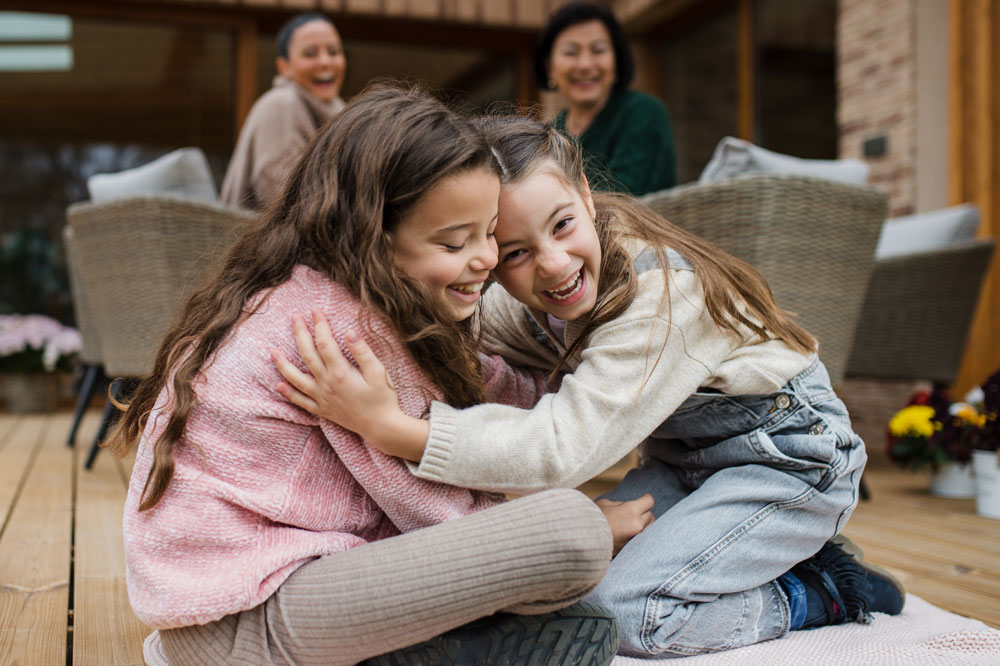 two sisters hugging after saying sorry